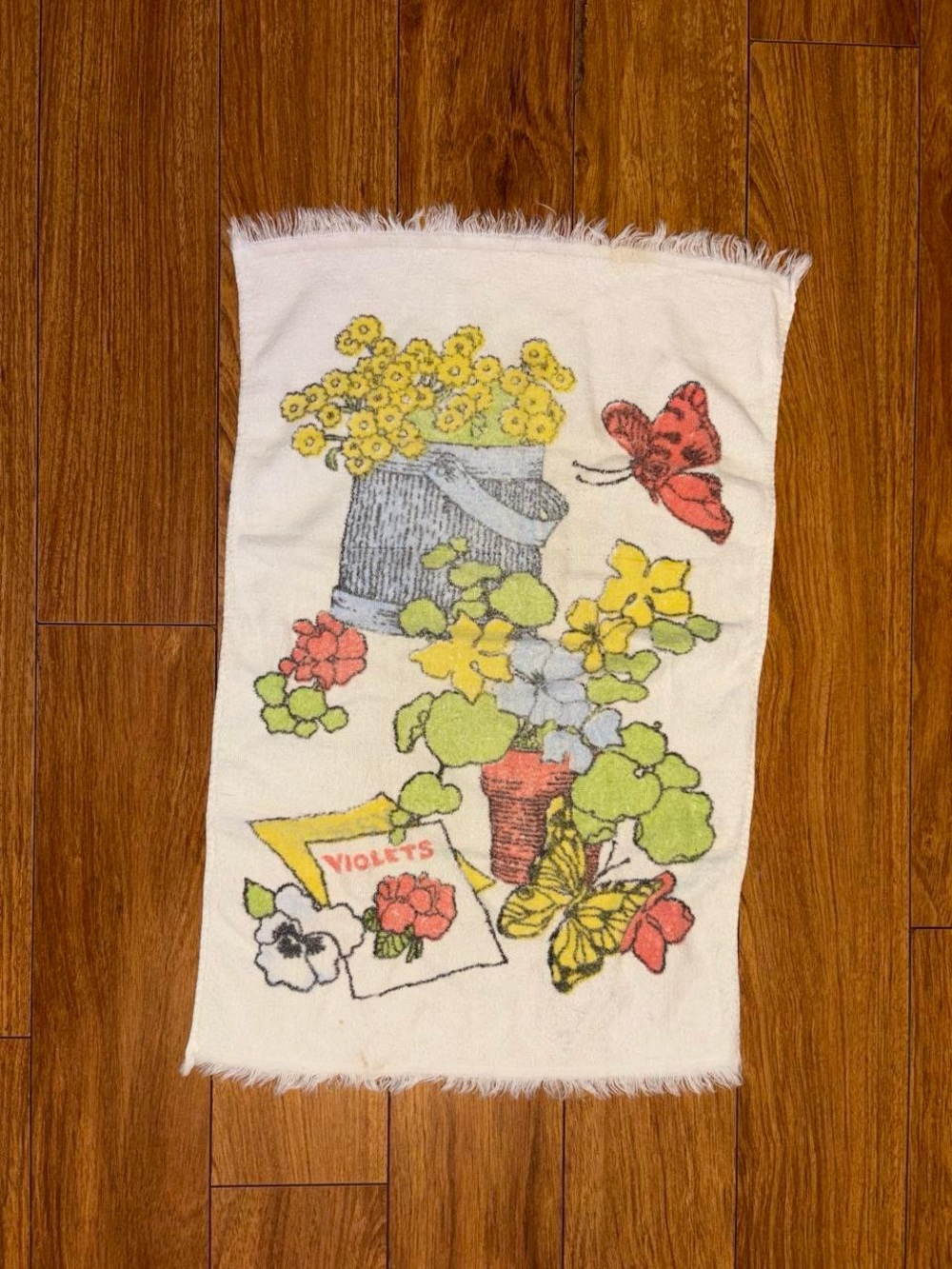 Vintage 1970s hand towel with a floral design and butterflies